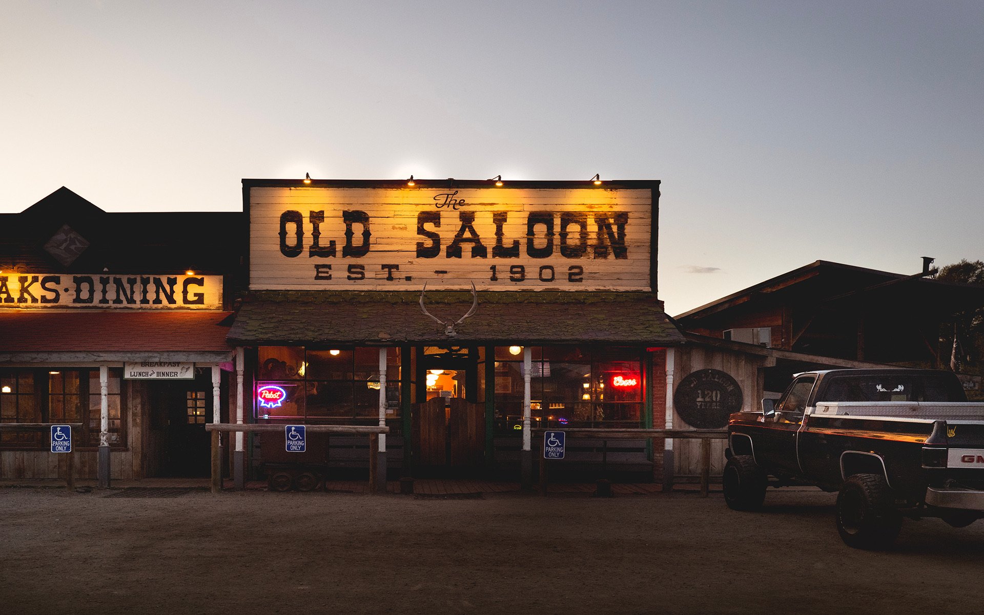 pickup truck parked next to the exterior of The Old Saloon in Montana