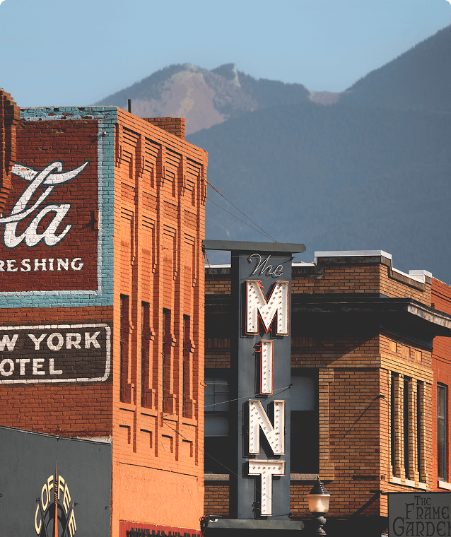 sign for The Mint Bar & Grill in Livingston, Montana with mountains in the background