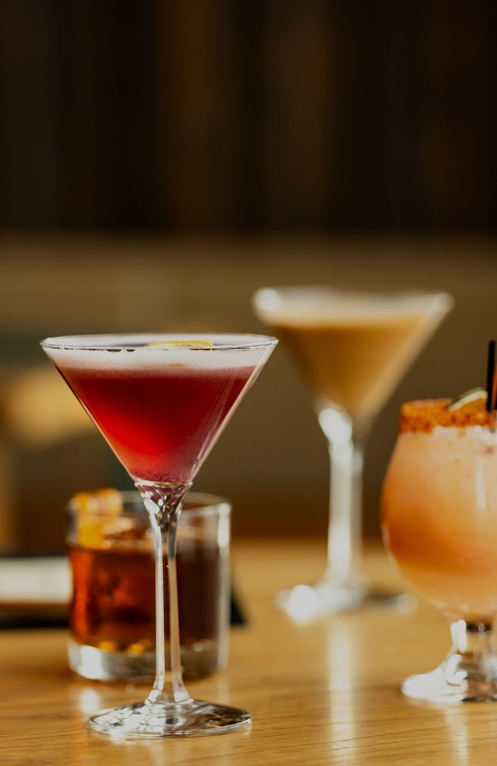 two martinis and two other cocktails on a table