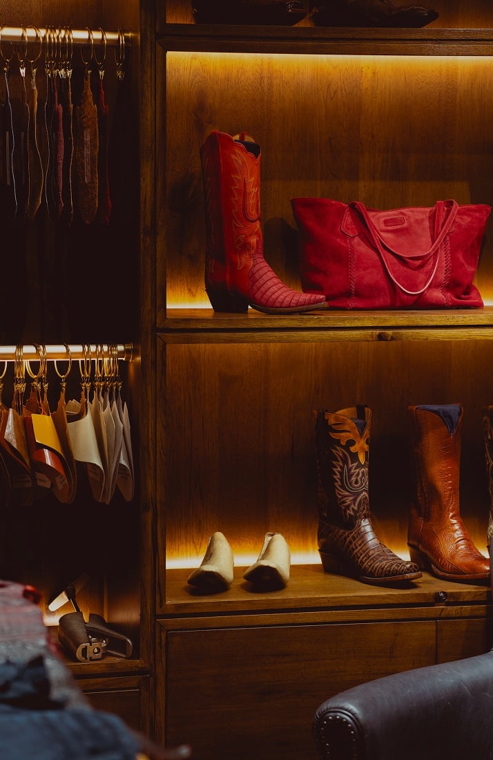 cowboy boots and a purse on display in a store